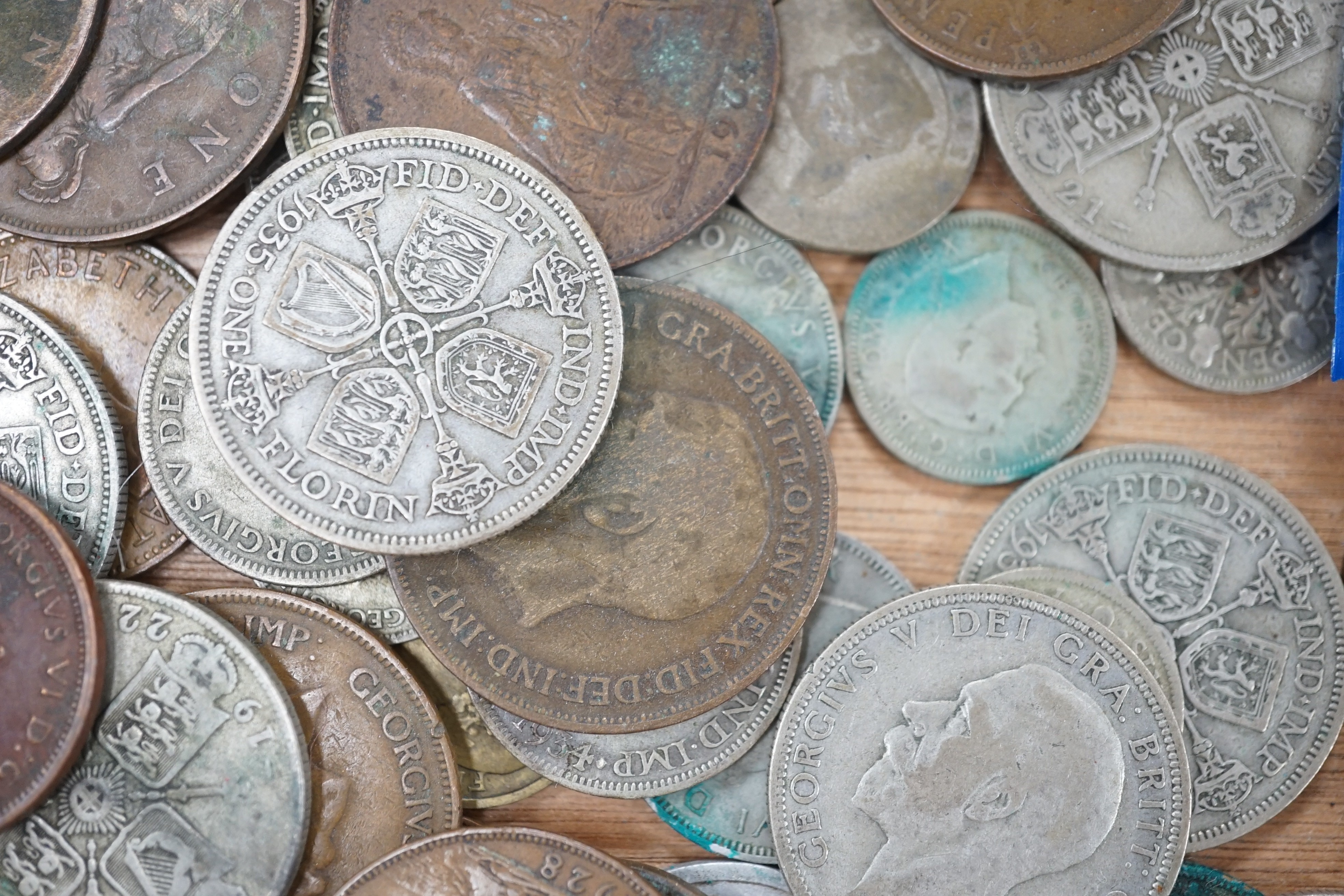 A collection of coins including a Victoria crown and two florins